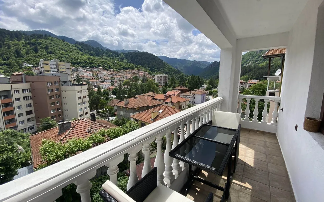 Balcony with white balustrade looking over the rooftops of Devin and the mountains