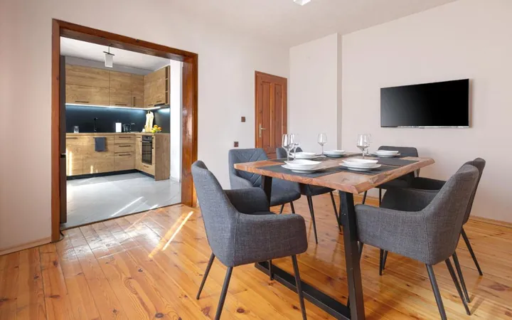 Dining table for four with the kitchen behind