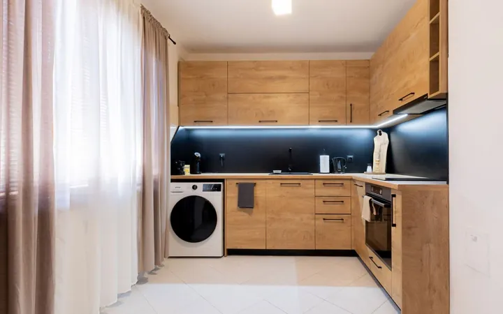 Wooden kitchen with oven, sink and washing machine